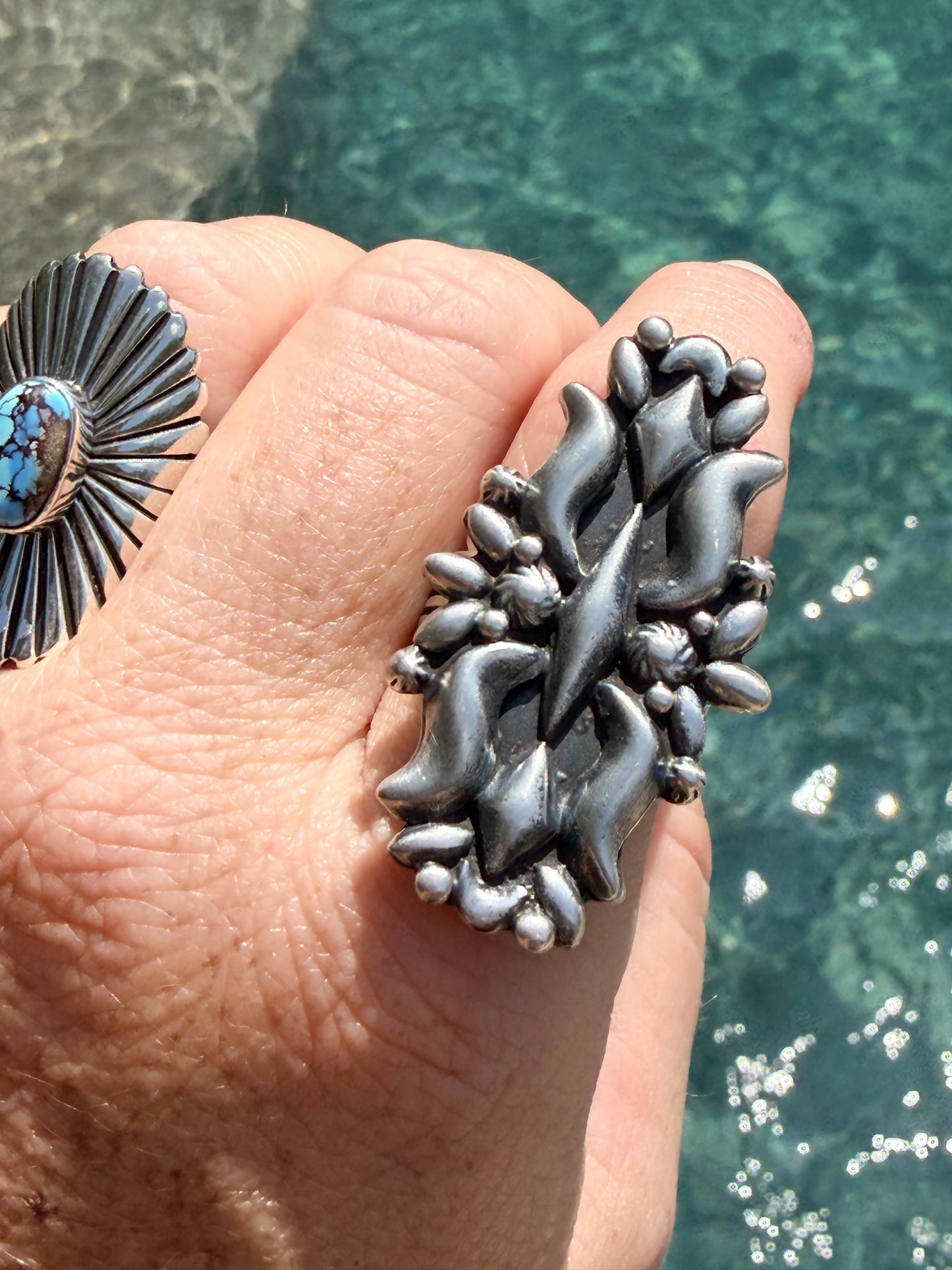 Handcrafted Native American sterling silver ring, featuring a intricate concho-style design with dimensional silver details